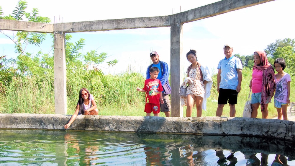 family-trying-hotspring-water